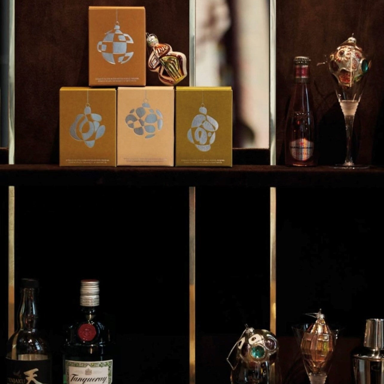 Alcohol bottles and boxes on a dark surface with a blurred background
