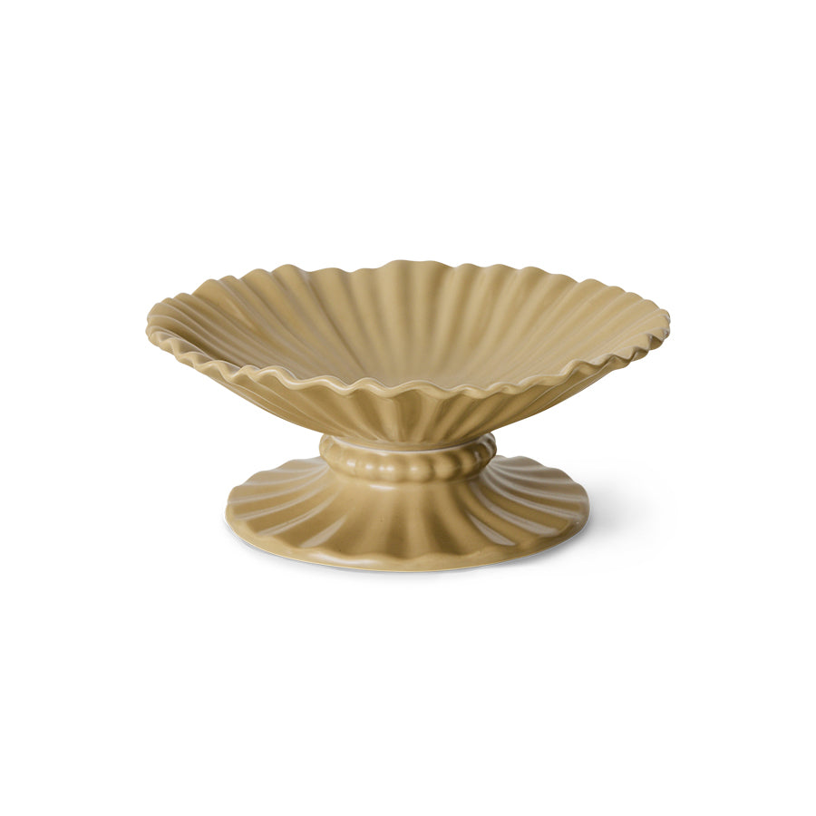 Decorative ceramic bowl with scalloped edge on a white background