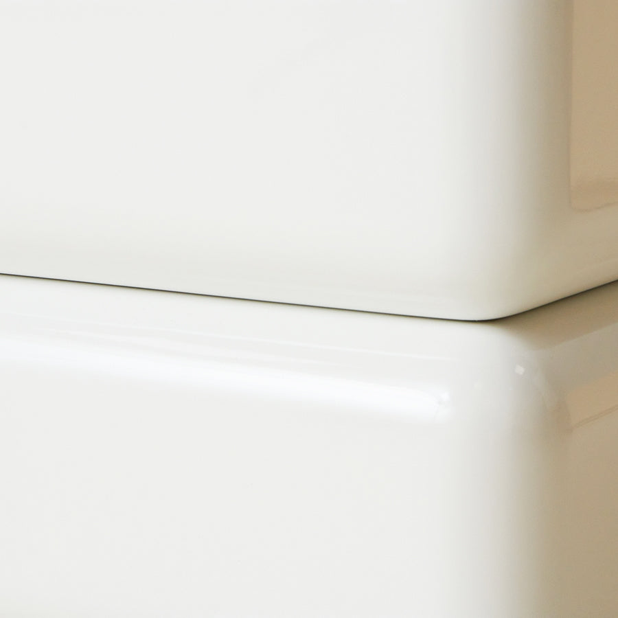 Close-up of a white coffee table with a light brown background