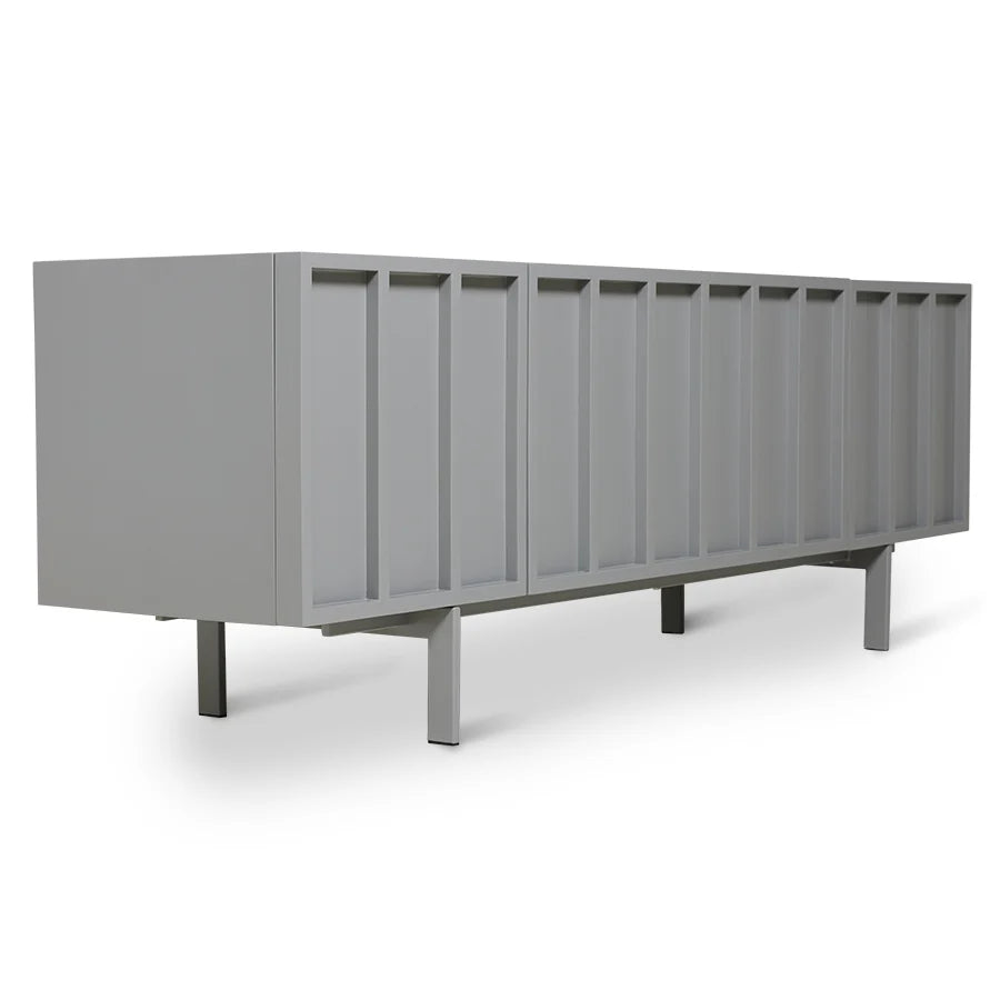 A modern sideboard or credenza in a solid medium gray finish, featuring vertical panel details on the front and tapered metal legs, shown against a plain white background.
