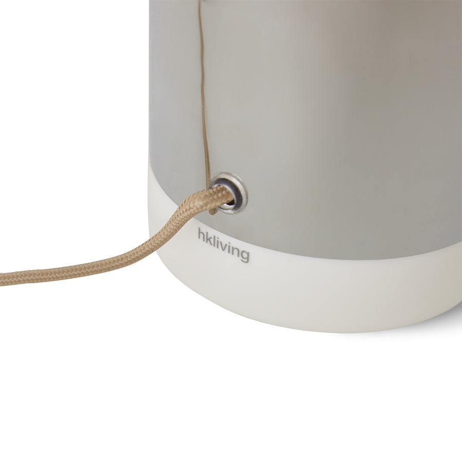 Close-up of a gray lamp with a beige cord on a white background, featuring the hkliving brand.