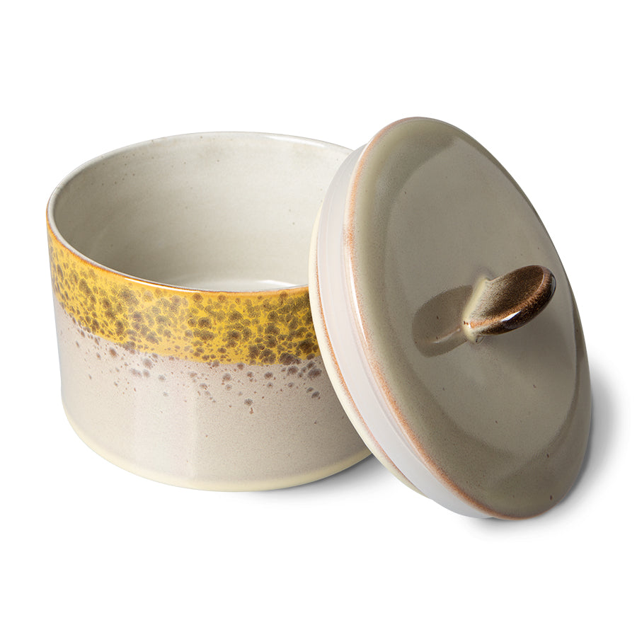 Ceramic container with a yellow accent band on a white background