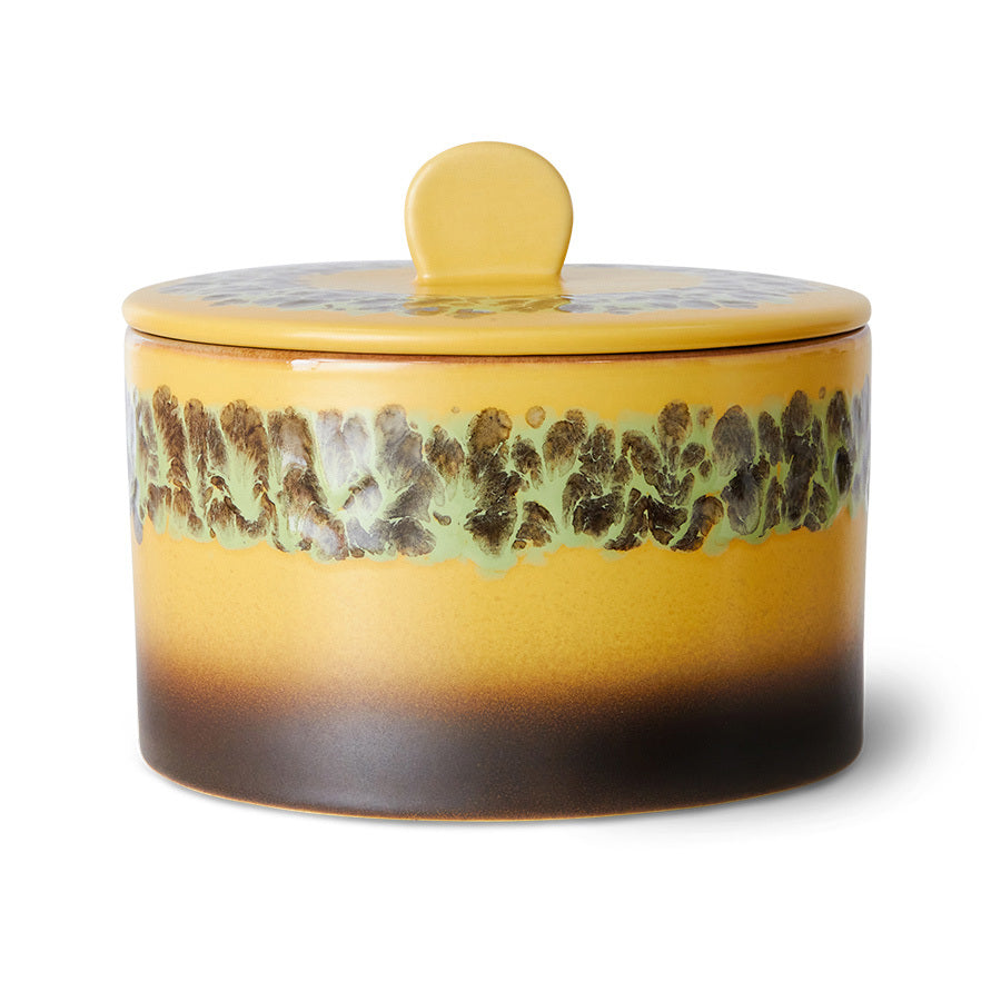 Yellow ceramic jar with a textured design on a white background